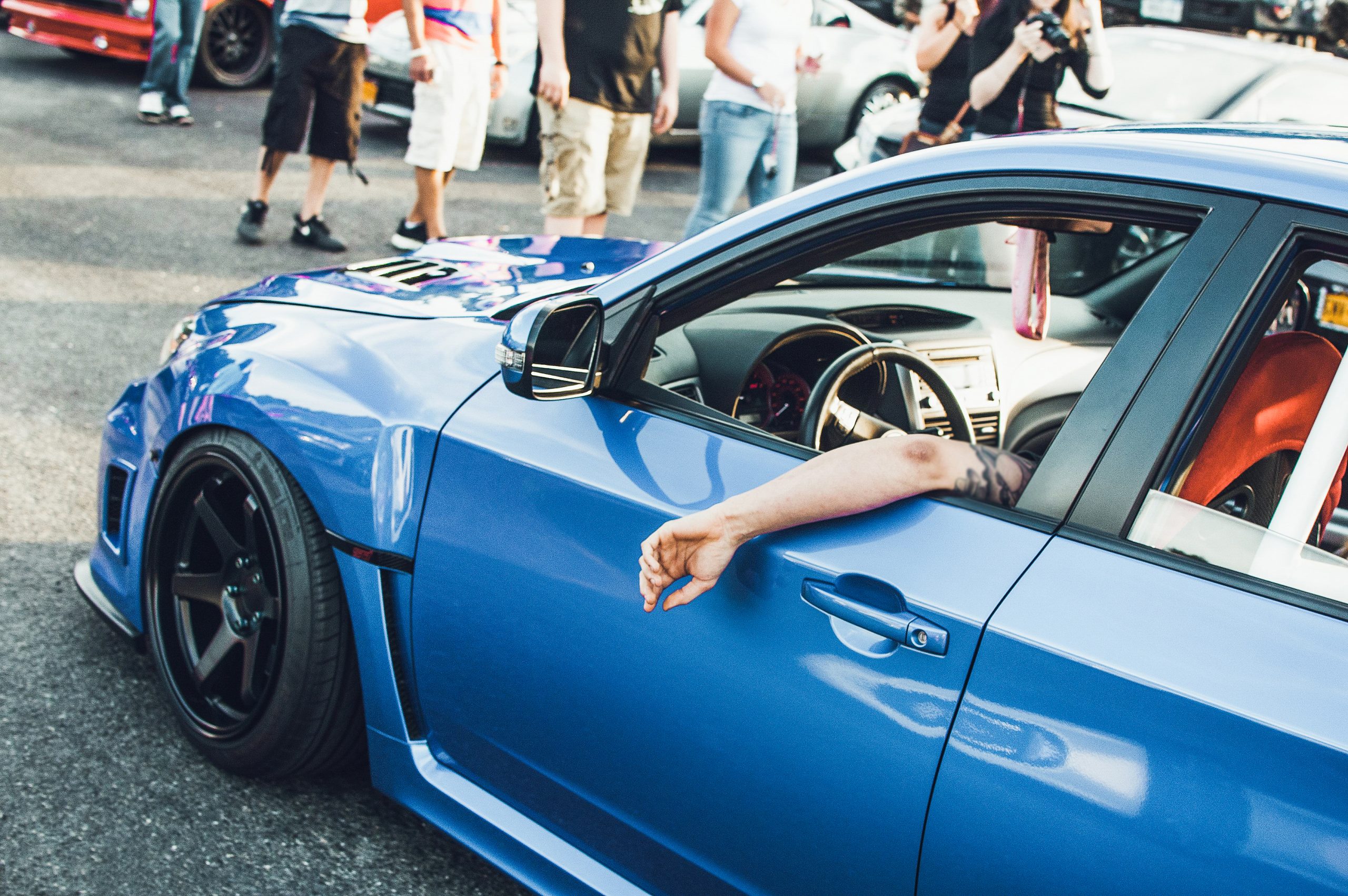 Man sits in blue BMW on the street